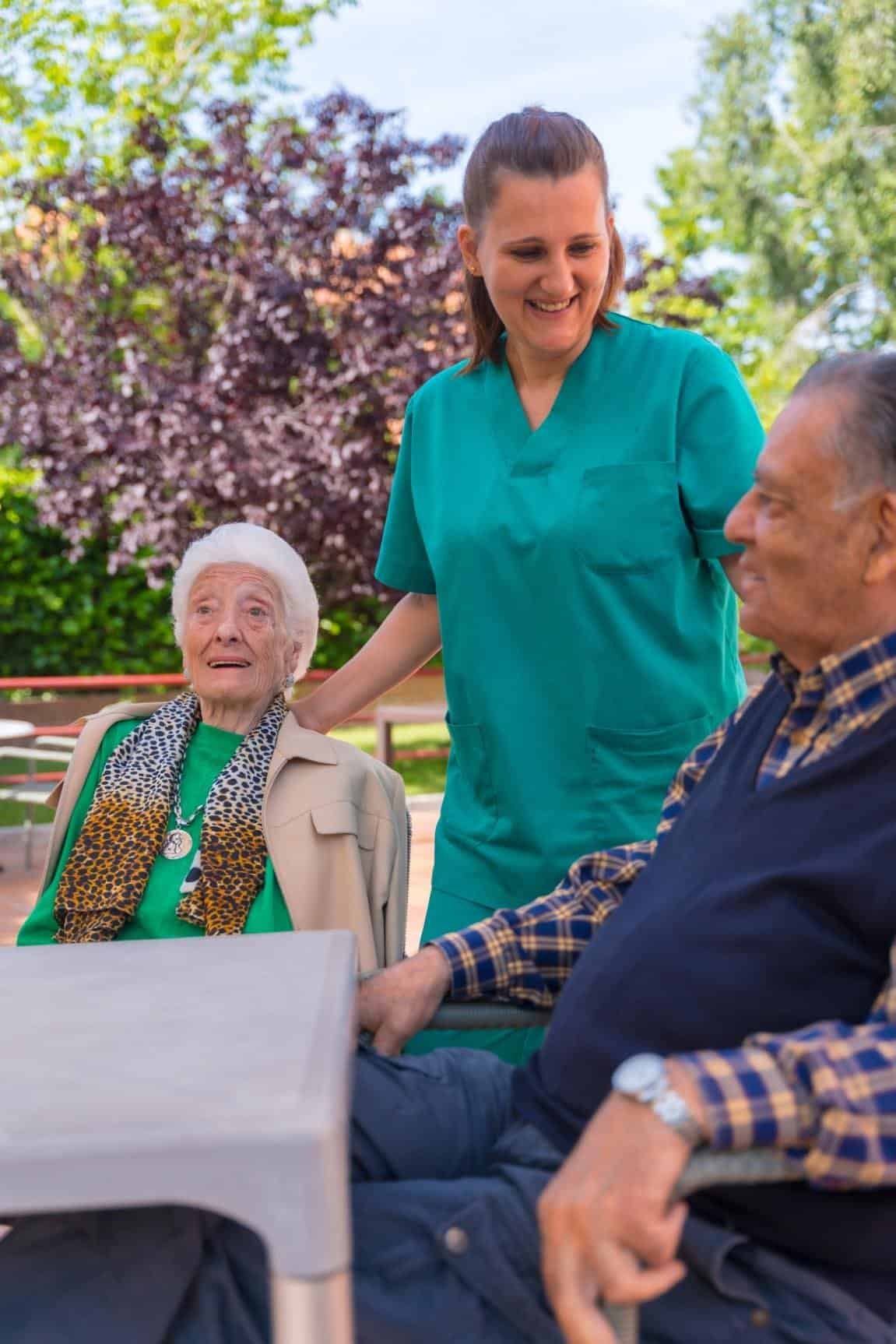 two-elderly-people-with-the-nurse-in-the-garden-of-2024-12-10-02-17-07-utc